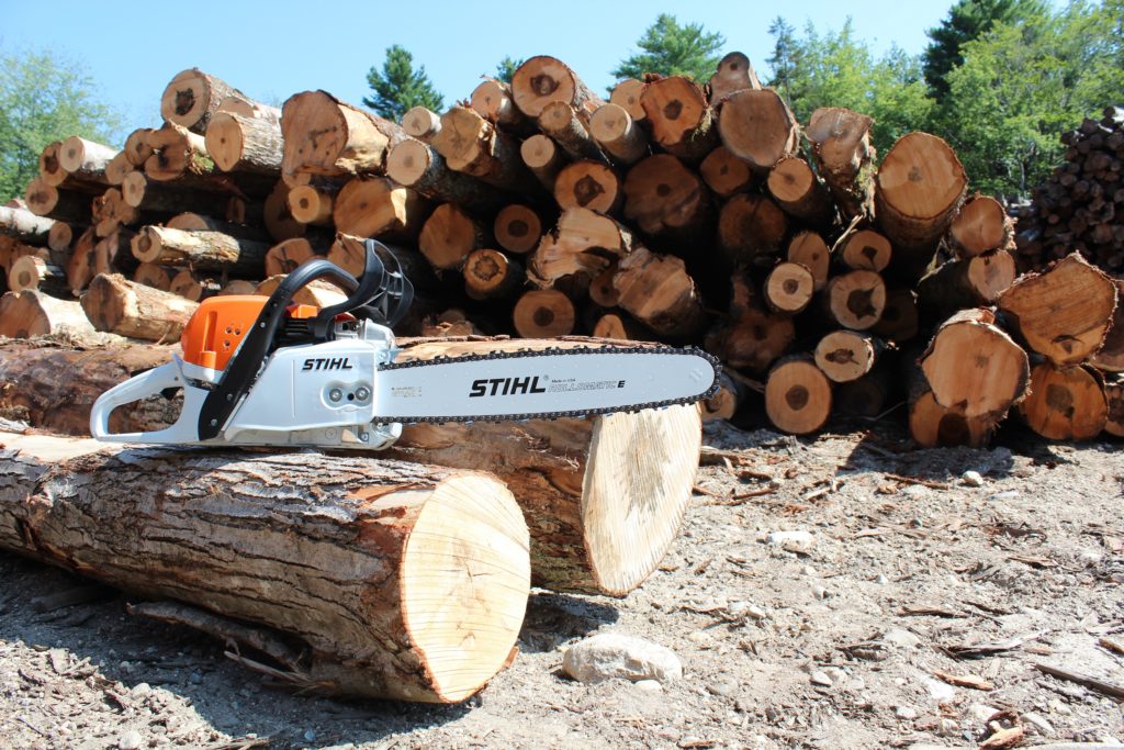 firewood and saw in yard